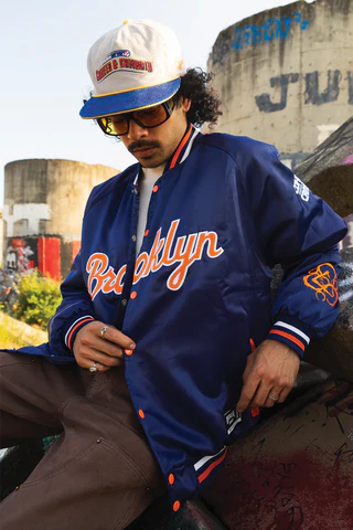 The Mosh Network - Male model displaying the Brooklyn Cyclones inspired 'Coheed and Cambria' hat, with jacket, complete with Coheed And Cambria brnading on arm.