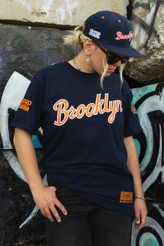 The Mosh Network - Display of the alternative blue Brooklyn Cyclones shirt and matching hat featuring Coheed and Cambria branding.
