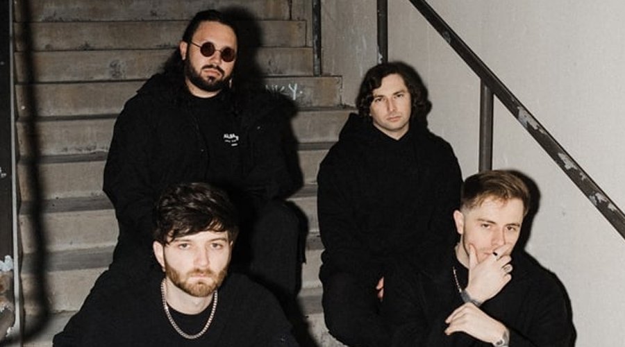THOUSAND BELOW Announce New Album ‘Buried In Jade’, Drop New Single “Palace Of Dread” & Reveal Summer Tour The Mosh Network - Thousand Below band promo circa 2025 depicting the band sitting on a staircase