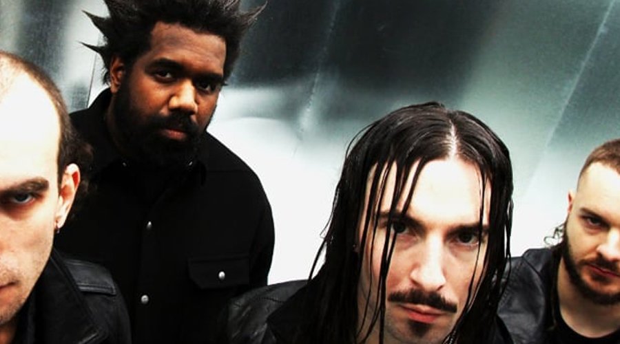 DREGG Sign With Fearless Records, Drop Cinematic “Dress Down” Video The Mosh Network - Promo photo of Australian band Dregg, featuring all four members standing against a metallic background with intense expressions.
