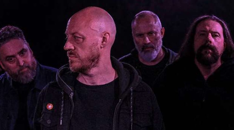 WARNING Sign to Relapse Records, Set to Release First New Album in Nearly Two Decades The Mosh Network - Warning band promo photo, 2025 lineup reuniting for new album cycle, photographed in a moody, atmospheric setting reflective of their doom metal sound.