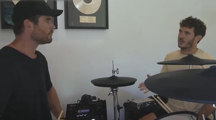 PARKWAY DRIVE’s Ben Gordon Taught Chris Hemsworth to Play Drums for Live Show with Ed Sheeran The Mosh Network - Parkway Drive drummer Ben Gordon gives drumming tips to actor Chris Hemsworth during a practice session for an Ed Sheeran performance, with electronic drums and gold record plaques visible in the background.