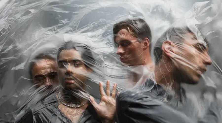 UNPROCESSED Drop New Single & Video “Beyond Heaven’s Gate” The Mosh Network - Unprocessed promotional photo from 2025 depicting the band behind a sheet of plastic