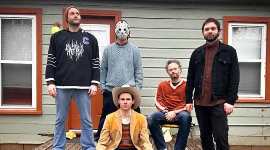 CHAT PILE and Hayden Pedigo Unveil “Demon Time” Music Video The Mosh Network - Chat Pile with politician/avante-garde Hayden Pedigo on a porch. 2025