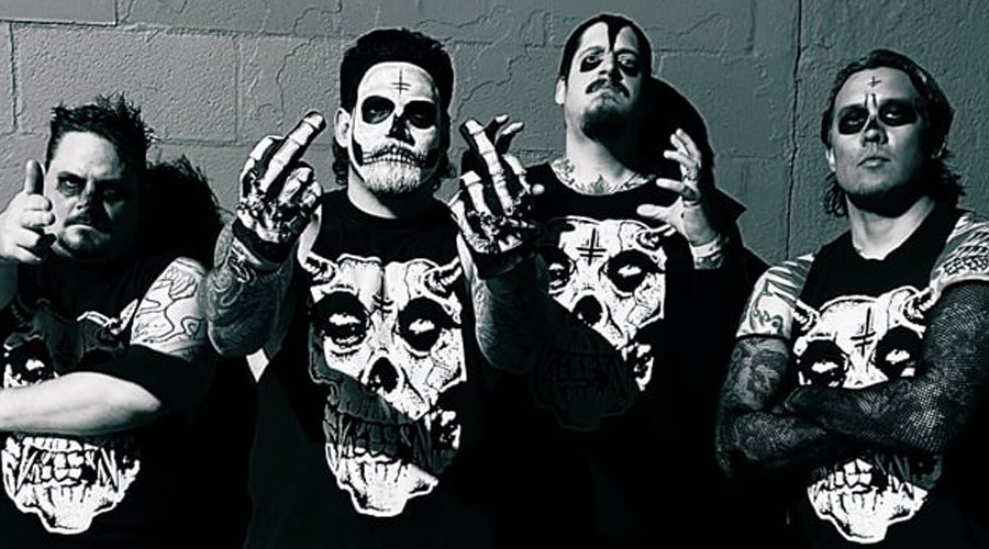 TWITCHING TONGUES Drop New Misfits Covers EP ‘Twitchfits Vol. 3’ The Mosh Network - Twitching Tongues band members dressed in Misfits-style skull shirts and corpse paint, posing against a wall in black-and-white.