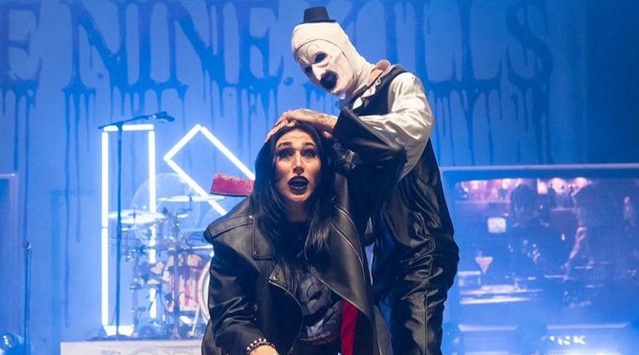 WWE’s Rhea Ripley “Killed” Onstage by Art the Clown During ICE NINE KILLS Headlining Set The Mosh Network - Art the Clown lunges toward WWE wrestler Rhea Ripley on stage during Ice Nine Kills’ live performance, part of a theatrical horror moment. Photo by Jeremy Saffer.